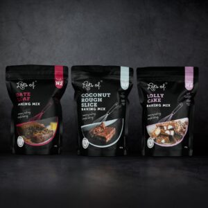 Lots of Baking Mixes Flexi 3 Pack Premium featuring Date Loaf, Coconut Rough Slice and Lolly Cake baking mixes.