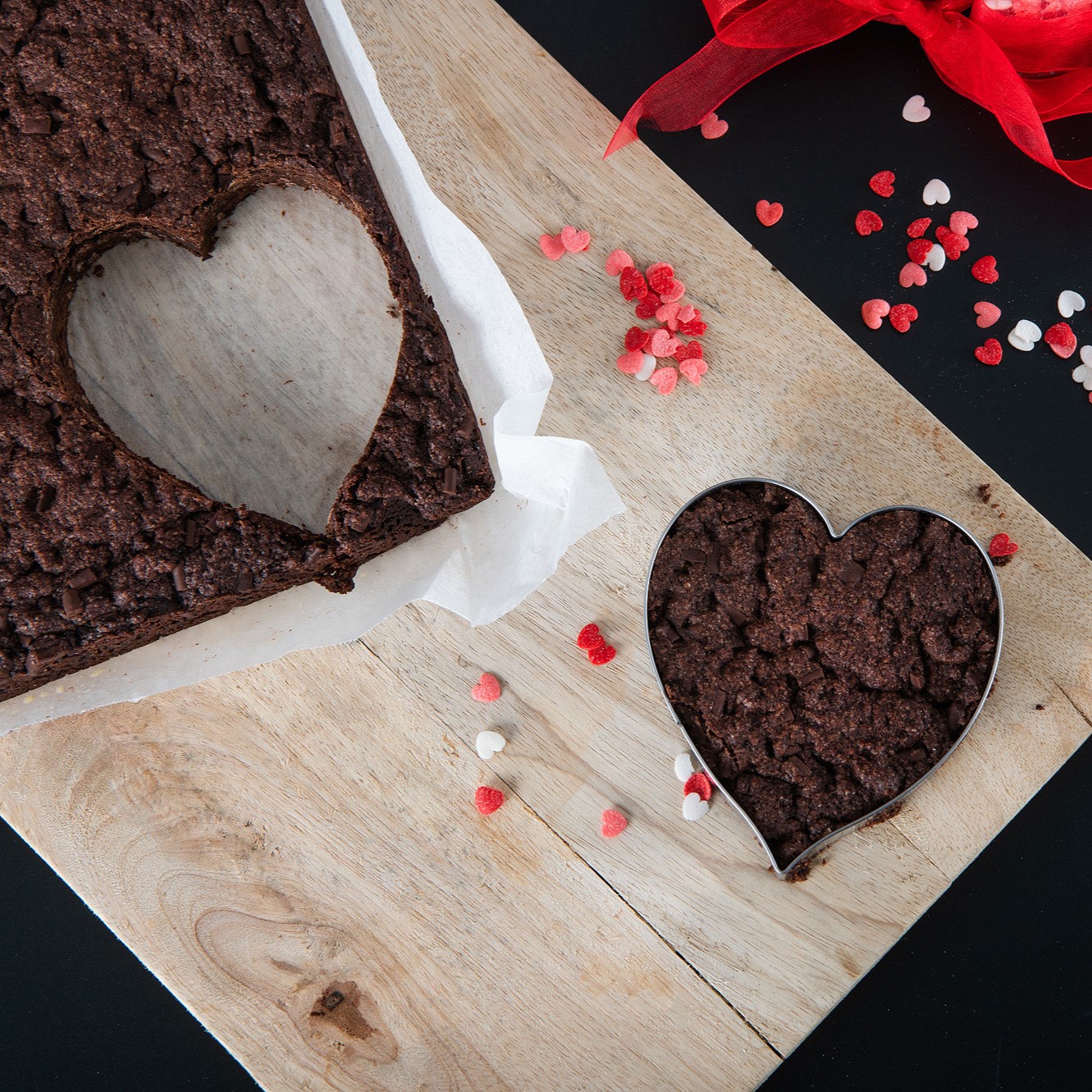 Chocolate Brownie Baking Mix Set 6 Heart-shaped homemade chocolate brownies with sprinkles and ribbon on a wooden board, styled for gifting and special occasions.