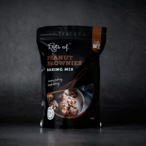 Lots of Baking Mixes Peanut Brownies Baking Mix pouch on a dark background, New Zealand made chocolate peanut biscuit baking mix for easy homemade baking.