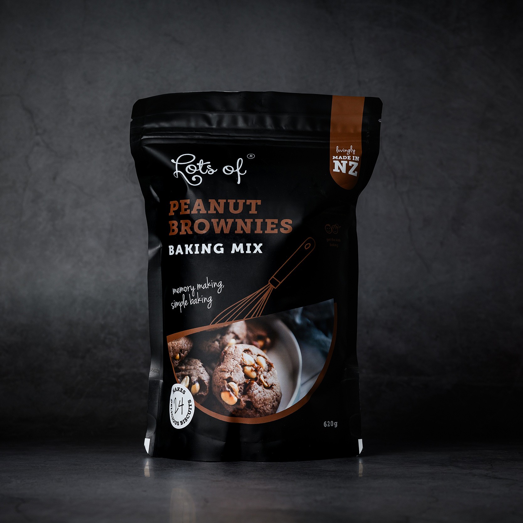 Peanut Brownies Baking Mix 4 Lots of Baking Mixes Peanut Brownies Baking Mix pouch on a dark background, New Zealand made chocolate peanut biscuit baking mix for easy homemade baking.