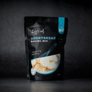 Lots of Baking Mixes Shortbread Baking Mix pouch on a dark background, New Zealand made shortbread biscuit baking mix for easy homemade baking.