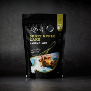Lots of Baking Mixes Spicy Apple Cake Baking Mix pouch on a dark background, New Zealand made apple spice cake baking mix for easy homemade baking.